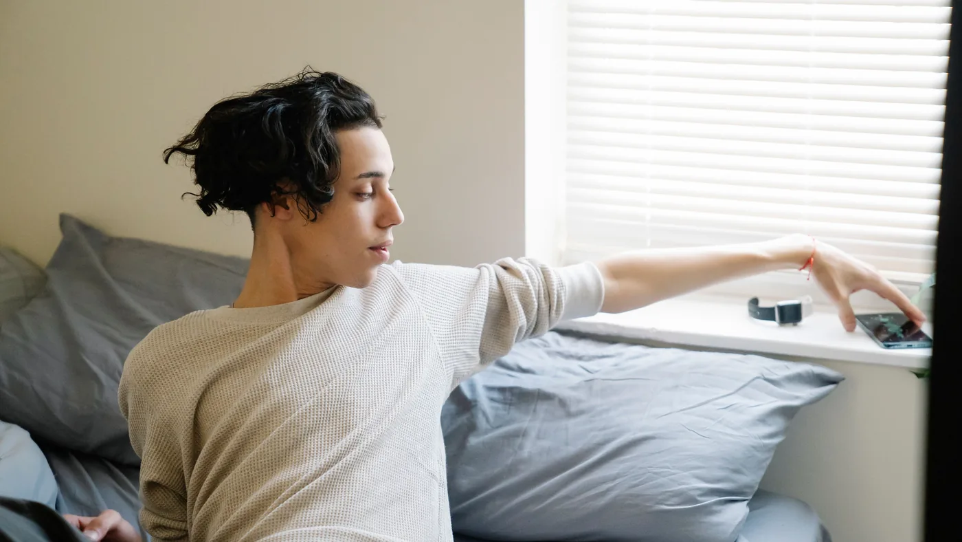 An alarm on a dresser, across the room from the bed — the oldest fix there is, and still the principle every good alarm app is imitating.